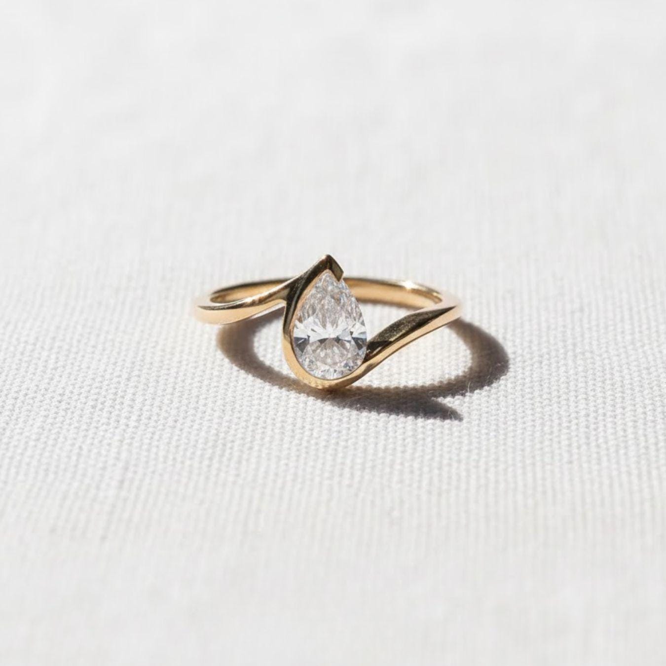 1.5 Ct Pear Cut Diamond Half Bezel Engagement Ring
